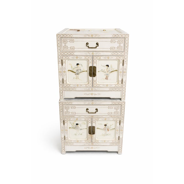 A beautifully detailed pair of vintage chinoiserie lacquer nightstands, featuring intricate hand-applied mother of pearl...
