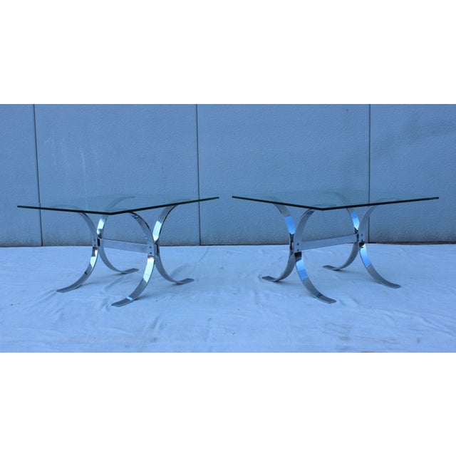 Stunning pair pf 1970's steel and chrome side tables with glass top, in vintage original condition with minor wear to the...