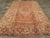 An antique Turkish Oushak room size carpet. An enormous, bold reversing turtle palmette border on a salmon-buff ground...