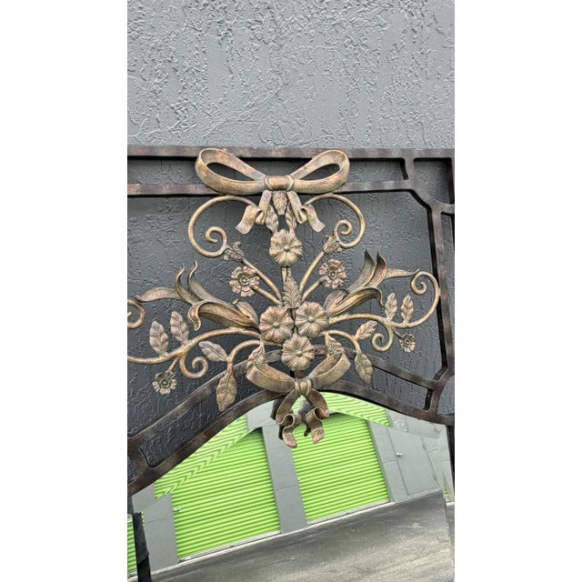 This is an exquisite and substantial mirror labelled LaBarge. It is iron and features flowers and bows. The mirror itself...