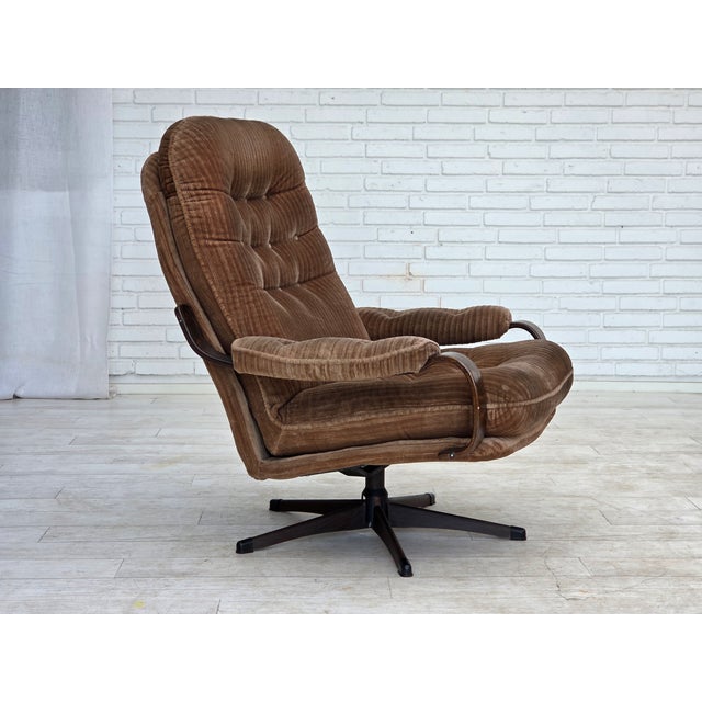 1970s, Danish swivel armchair. Brown furniture corduroy, bent beech wood, metal base with wood imitation. Original very...