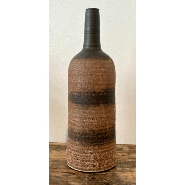 Exude an air of organic sophistication with this striking vintage studio pottery vase. A masterful example of mid-century...