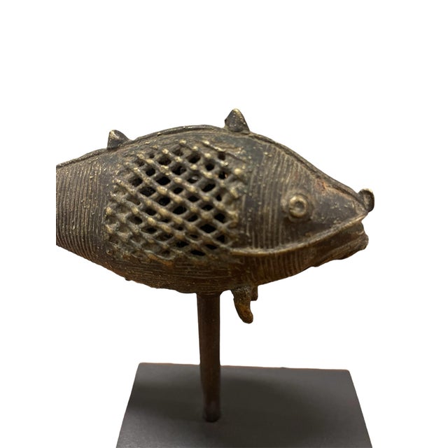 A charming bronze fish displayed on a custom stand. Dhokra are unique sculptures from Orissa India made using the lost wax...
