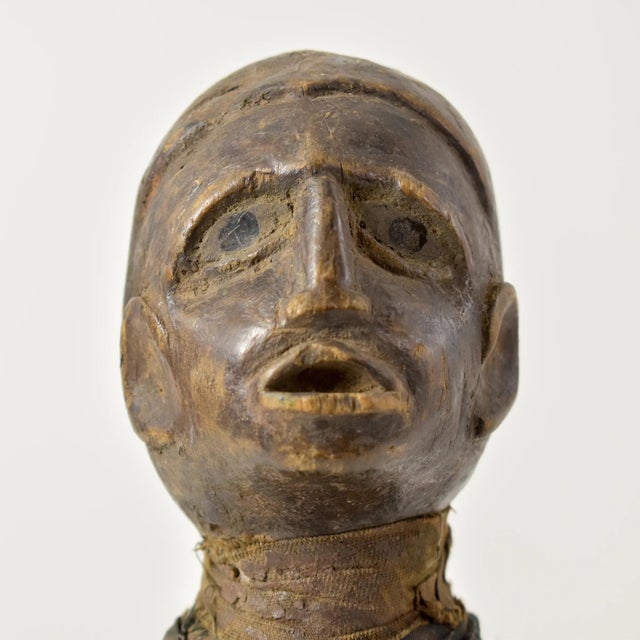 This Pere Miniature Mummy figure contains glass eyes and is wrapped in a cloth. The Pare people in Tanzania, residing in...