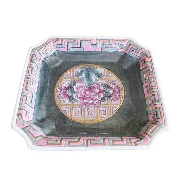 A beautiful famille rose trinket dish or catchall. Created from ceramic, this piece is square in shape, with scalloped...