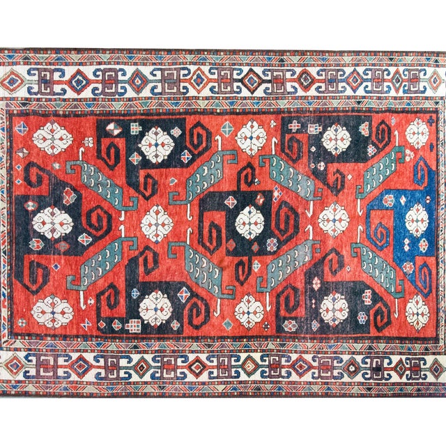This exceptional and rare early 20th-century Persian Kazak rug is a bold, graphic statement piece with undeniable...
