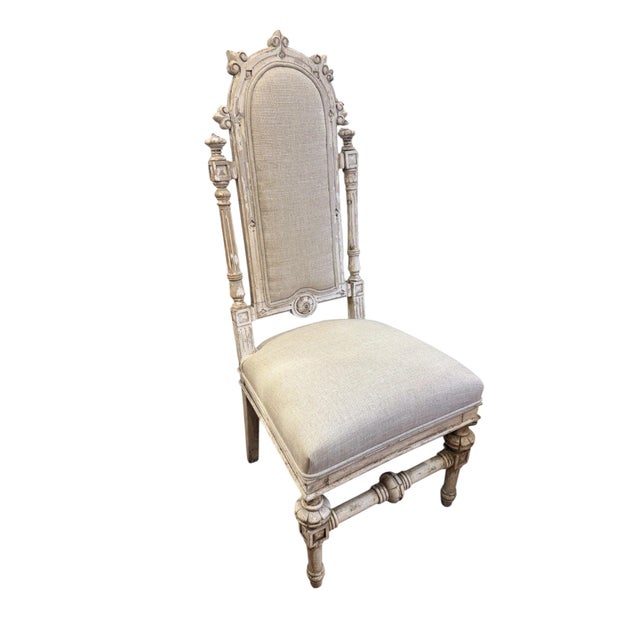 Set of six Louis XVI style French carved dining chairs with rustic faded paint finish. Newly upholstered in beige linen....