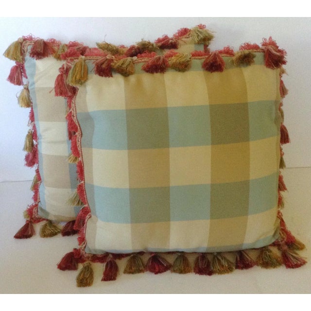 This pair of pillows has the neutral hues of blue, gold and green woven into an overlapping plaid and all trimmed with a...