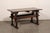 A French oak wood trestle table from the early 19th century. This antique oak wood table from France features a...