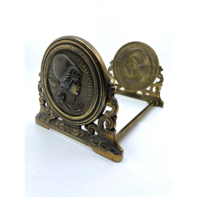 Antique cast iron with brass coating expandable book end. Opens and closes with ease. HJ Judd Minerva expanding bookend or...