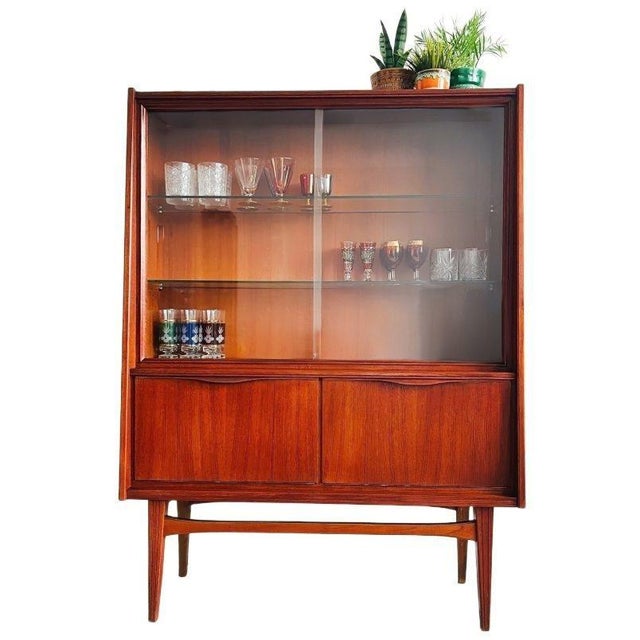 Beautiful, elegant vintage mid-century Danish Design display cabinet made of solid teak and teak veneer from the 1960s....