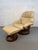 Relax in comfort with this stylish beige leather recliner chair and matching ottoman. The chair features a high, cushioned...