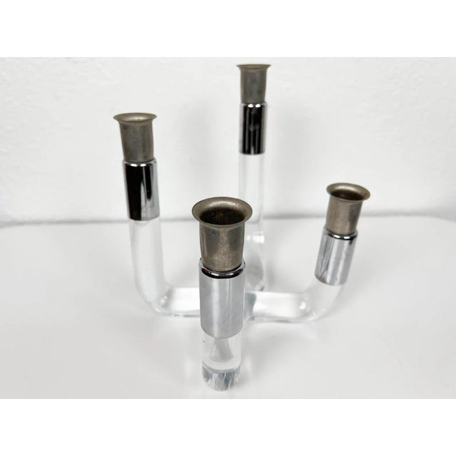 Vintage lucite and chrome candelabra with 4 varied height candlesticks. Year: 1970s Style: Mid Century Modern Dimensions:...