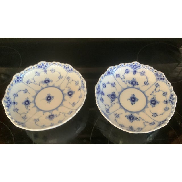 Full lace version, delicate open-work, pierced lace border on scalloped rim. Shallow serving bowl resting on an elegant...