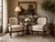 An elegant pair of vintage French Empire-style armchairs featuring beautifully carved swan-form armrests highlighted with...