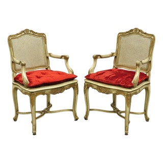 Vintage French Louis XV Style Cream Painted Carved Wood Cane Arm Chairs - A Pair For Sale