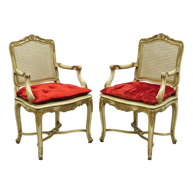 Vintage French Louis XV Style Cream Painted Carved Wood Cane Arm Chairs - A Pair For Sale