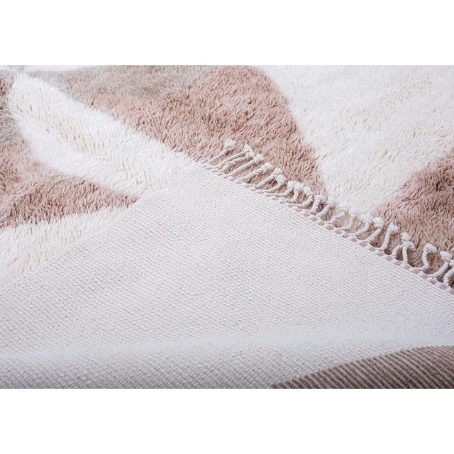 A modernist totem rising through wool: bold, balanced, and entirely its own. Angular shapes in deep and light taupe stack...