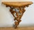 Decorative vintage Italian Florentine style wall shelf. Features a gilt leaf surface with carved wooden floral scrolls...
