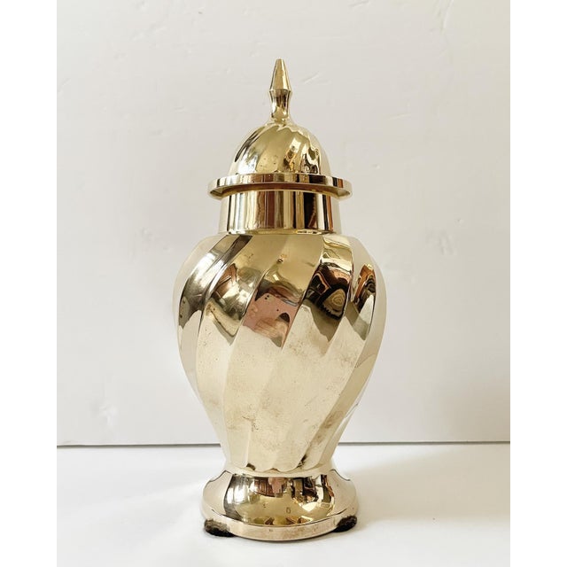 A gorgeous solid brass ginger jar with a lovely swirl decoration and great top finial