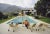 Slim aarons estate limited edition c print 40 x 30'' inches unframed. ' kaufmann desert house ' lita baron talking with a...