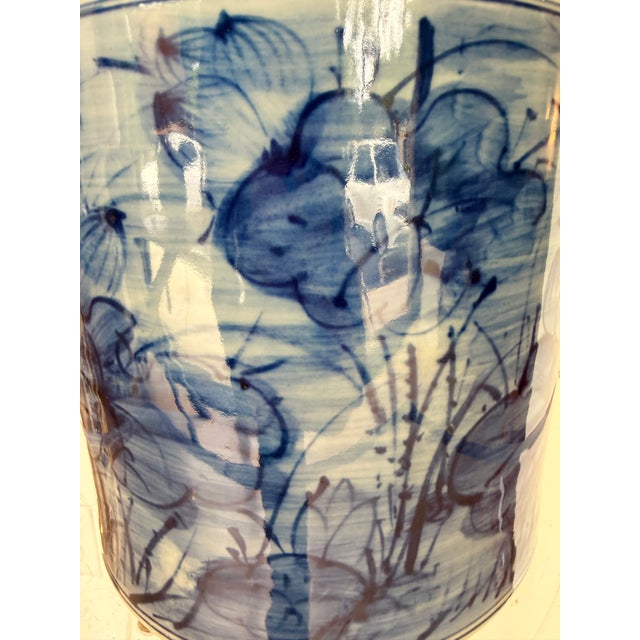Bring timeless elegance to your home with this contemporary blue and white ceramic vase. Featuring an artistic floral...