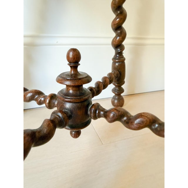 Antique English oak footstool featuring beautifully turned barley-twist legs, twisted stretchers, and a decorative center...