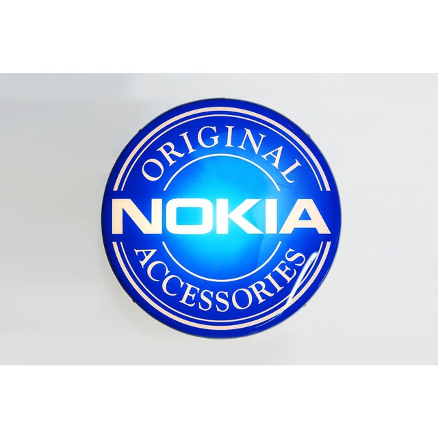 Rare wall-mounted advertising sign featuring the iconic Nokia logo, a symbol of innovation and reliability in the...