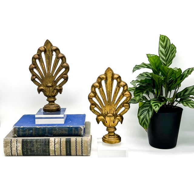 Striking and elegant pair of decorative brass finials mounted on lucite bases. Crafted in the mid-late 20th century, each...