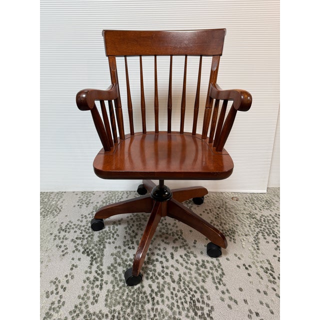 Design Plus Gallery presents a Wooden Office Chair from Nichols & Stone. The chair has a spindle back with carved arms...