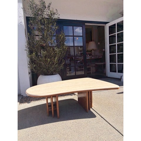 Vintage coffee table with irregular rounded triangular top in travertine stone. Top has a honed finish with visible...