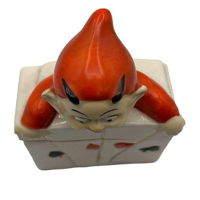 Rare Post-War ceramic case from Germany, likely by Bayreuth. It features a playful devil-like baby figure hanging over...