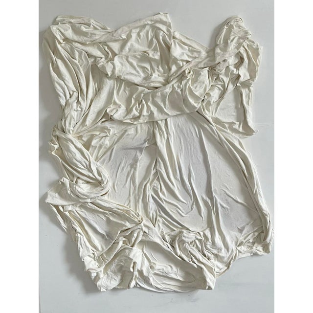 “Veiled” is a sculptural textile canvas that captures the tension between what is hidden and what is holy. Draped in soft...