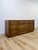 This vintage mid-century dresser stands out for its distinctive bowtie inlay detailing, a hallmark joinery technique...