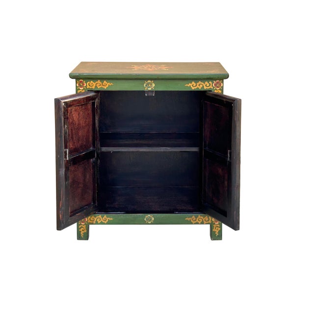 This handcrafted wooden cabinet features the vibrant and soulful aesthetics of Himalayan or Tibetan folk art. The piece is...