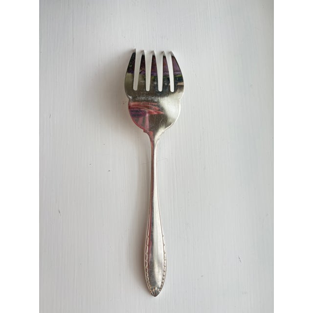A large silverplate fish serving fork by Christofle, France, bearing the maker's oval "CC" mark (Charles Christofle,...
