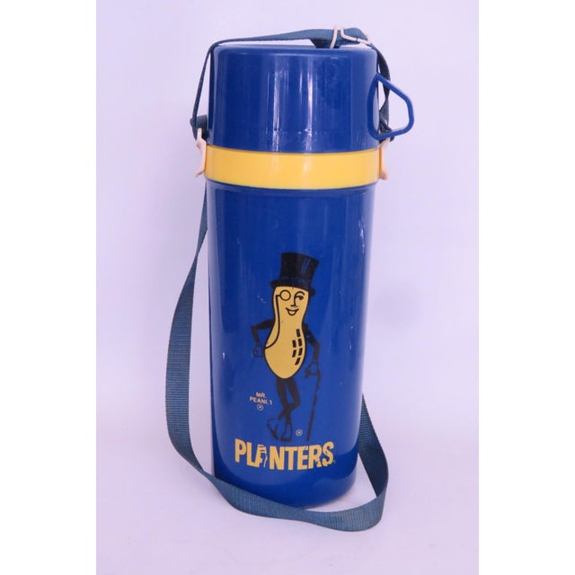 This gorgeous Travel Thermos is made of plastic with a fabric strap. This wonderful piece is marked on the bottom as being...