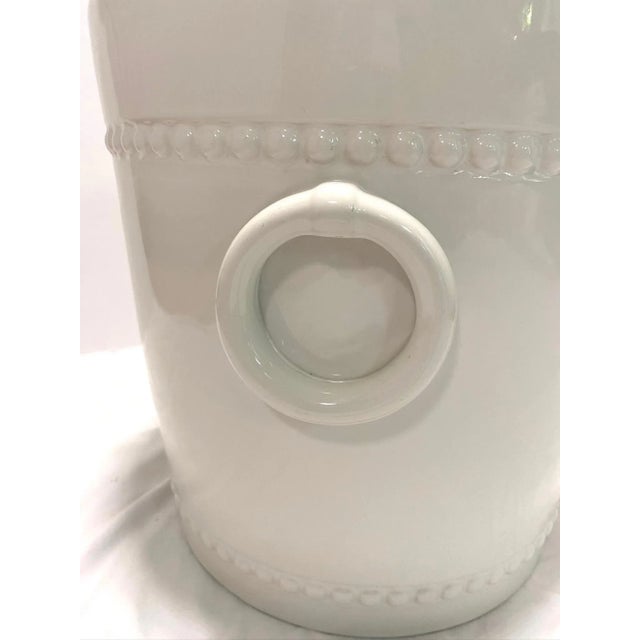 A substantial 1970s Italian white ceramic cachepot featuring applied ring handles and raised beaded band detailing at the...