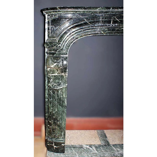 Third quarter 19th century Louis XIV style French mantel with paneled entablature, central carved acanthus motif, and...
