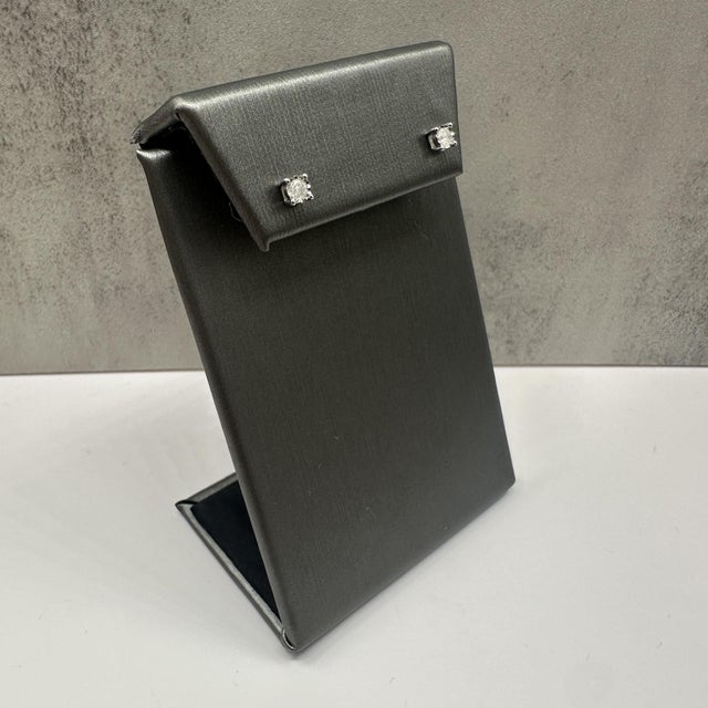 These classic natural diamond stud earrings in 10kt white gold feature 0.20 carats total weight of I, I quality round...