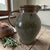 This exquisite hand-thrown stoneware pitcher by an ununknown studio potter brings timeless, organic warmth to your...