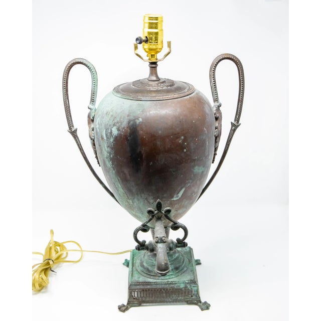 Offering this gorgeous patinated copper water vessel that was converted to lamp. The majestic shape of this old urn is...