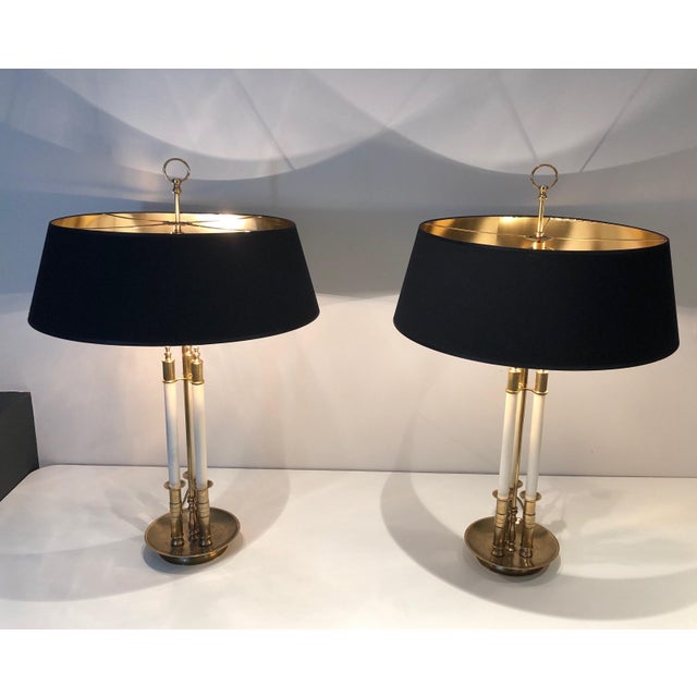 This very elegant pair of neoclassical style table lamps is made of brass with white lacquered elements. This is a French...
