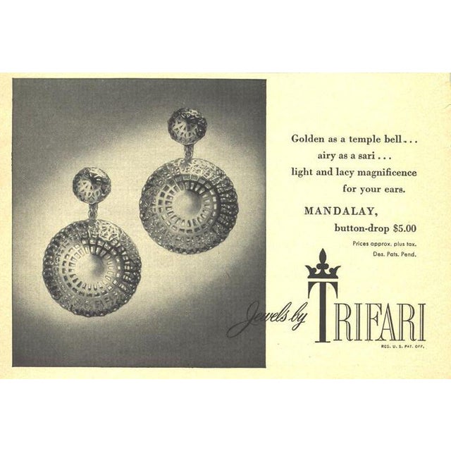 1955 rhodium plated round domed filigree top with larger round filigree drop clip earrings. Marked crown "TRIFARI" on the...