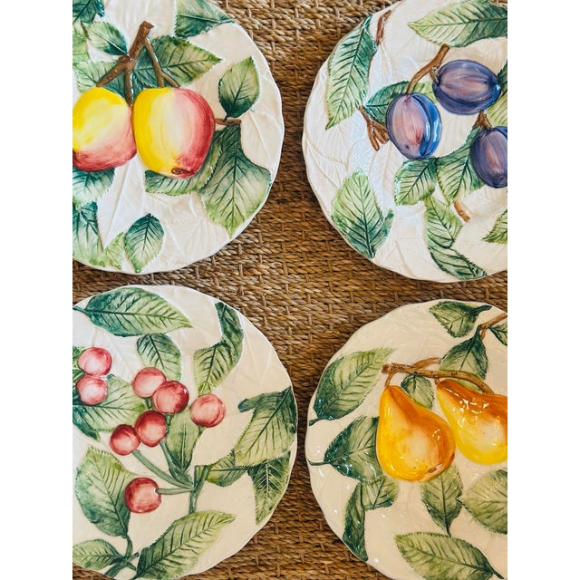 A delightful set of four vintage Italian Majolica fruit plates, each hand-painted in vibrant botanical colors with raised...