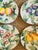 A delightful set of four vintage Italian Majolica fruit plates, each hand-painted in vibrant botanical colors with raised...
