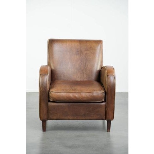This beautiful sheepskin armchair has a rugged vintage look and comes in a light cognac color. The armchair features a...
