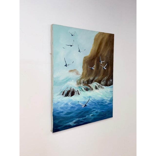 This original oil painting captures a dramatic coastal seascape, featuring a rugged cliff face rising above churning...