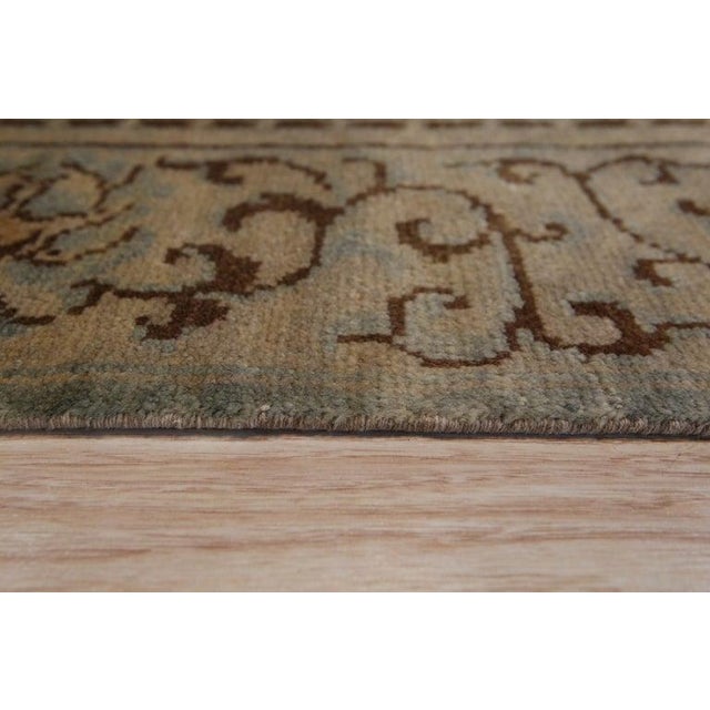 This green wool rug features a durable hand knotted pile construction. Originating from China, this area rug utilizes...