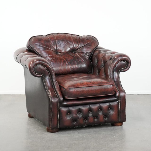 This delightful red mottled cowhide Chesterfield armchair in English style not only offers a beautiful look in your chosen...